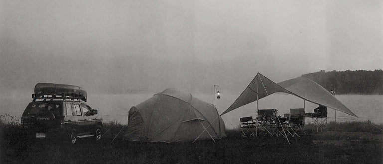 A toyota suv is parked next to a tent