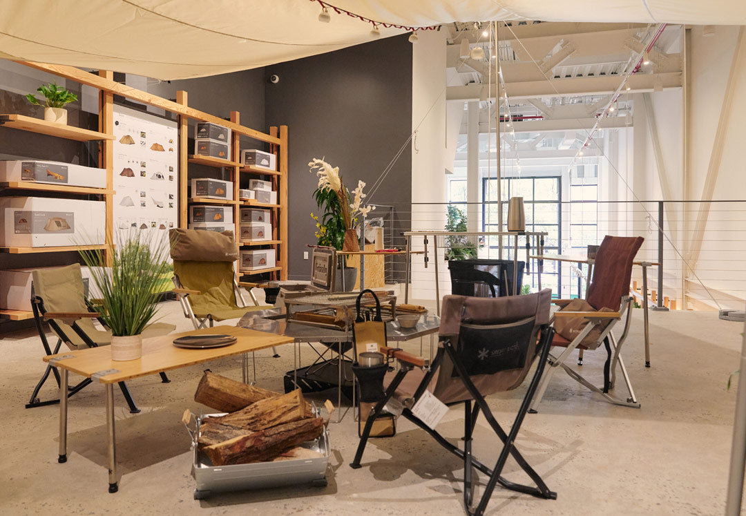 The loft at the Snow Peak Brooklyn location with camping fire pit display in the center with shelving on the left to house tents.